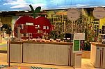 Cupboard with apples in the background an apple model