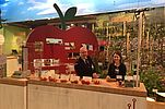 Two people at a cupboard with apples