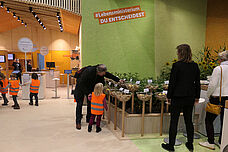 Visitors look at the potato varieties on display